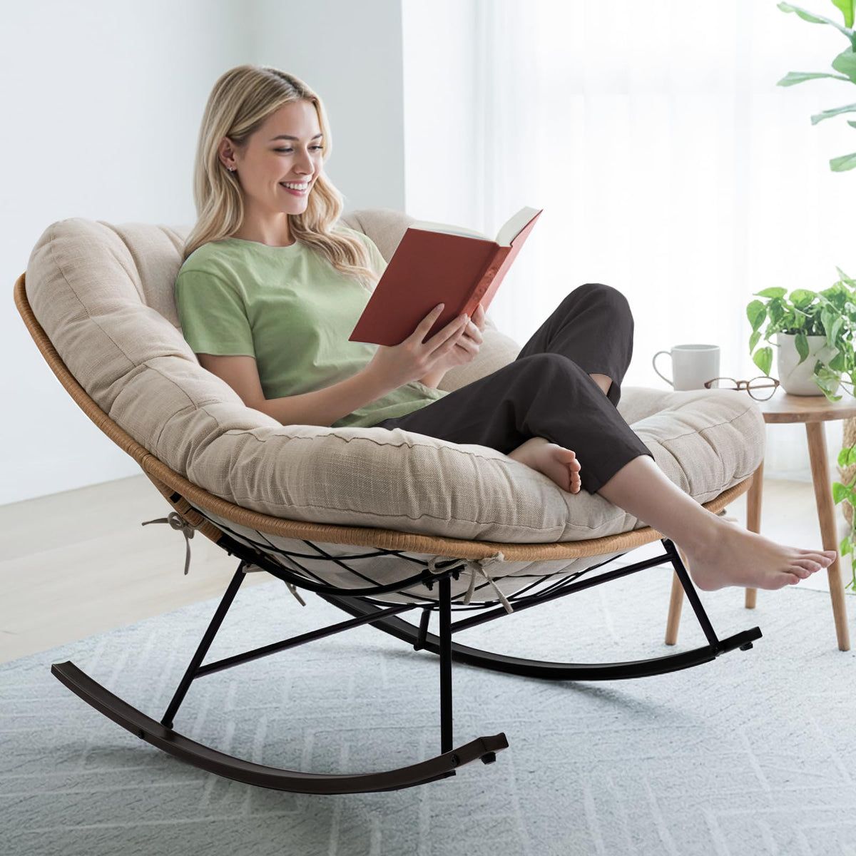 Metal moon rocking chair, featuring beige cushion and black matte frame, for daily lounge use