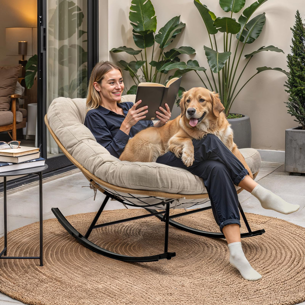 Metal moon rocking chair with beige cushion and black matte frame for relaxed seating