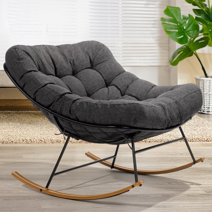 Metal moon rocking chair with grey cushion and wood-texture frame for indoor reading