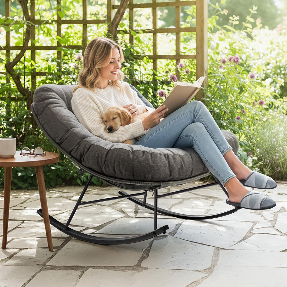 Metal moon rocking chair with grey cushion and black matte frame for relaxed seating